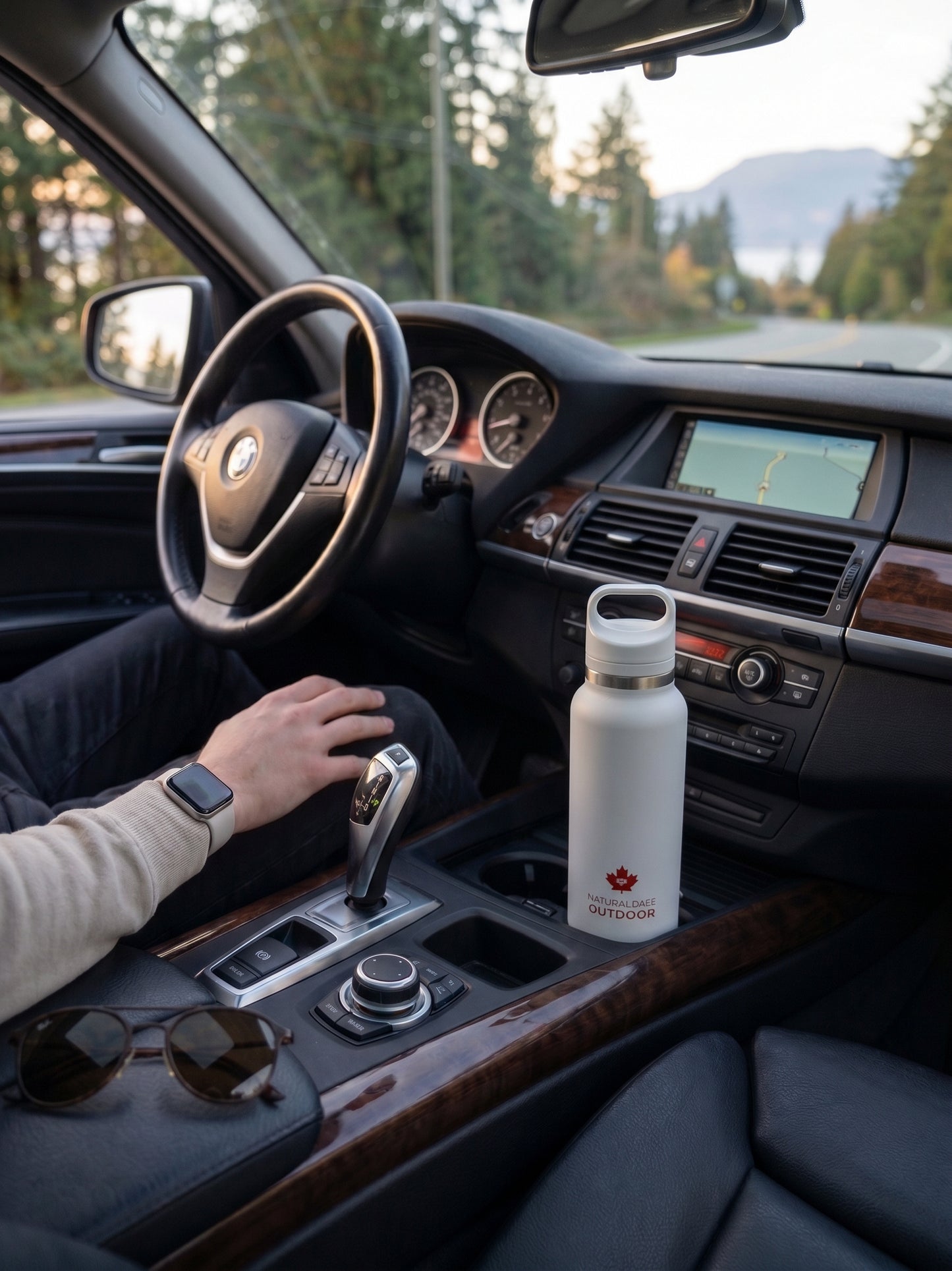 Person sitting in a car with a white water bottle on the dashboard